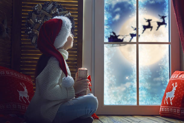 istock girl sitting by the window 877002452