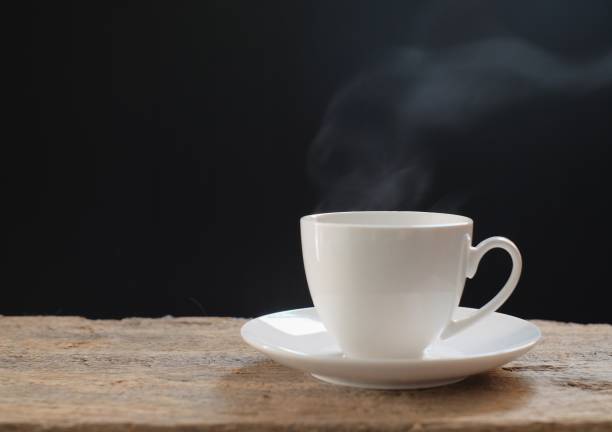 istock white coffee cup and hot smoke on wooden floor 877006048