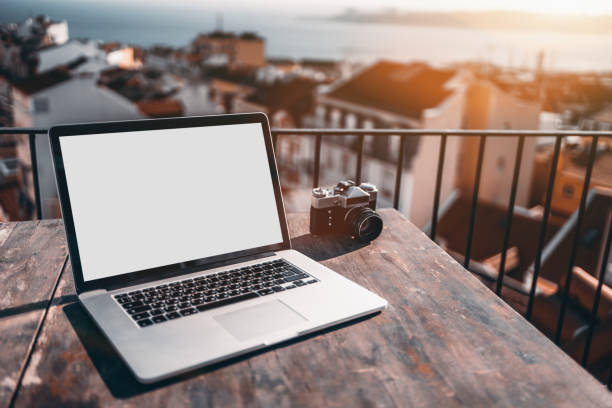 istock Netbook with blank scren mockup and retro camera 877008950