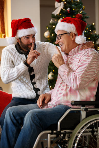 istock Grandson and grandfather talking secrets on Christmas 877008984