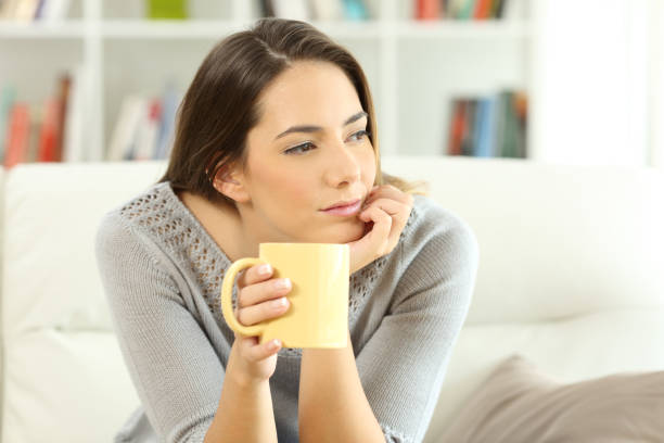 istock Pensive homeowner looking at side at home 877009952