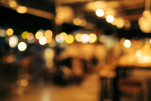 blur and bokeh of night party in a restaurant. blur and bokeh of night party in a restaurant. The night light in a party when people is enjoying and laughing. bokeh light stock pictures, royalty-free photos & images