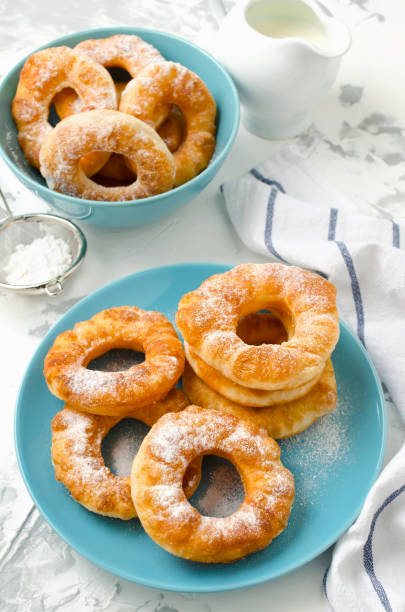 istock Homemade fried vanilla cottage cheese donuts on a white concrete background 877011250