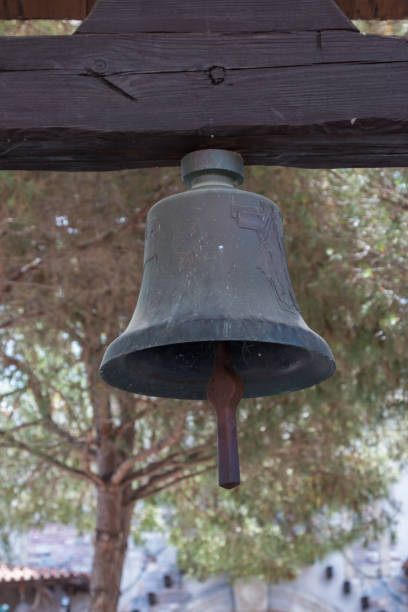 istock Ancient Little Bronze Bell Hanged on Wooden Crossbeam 877011990