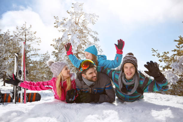 istock Happy family having fun on snow 877016008
