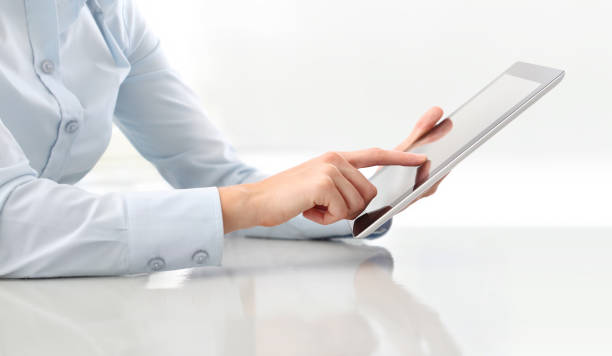 hand touching screen digital tablet close up on desk