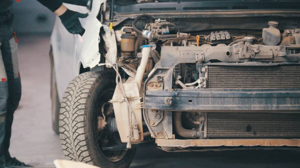 istock Damaged car preparing for professional diagnostics in auto service, close up 877018802