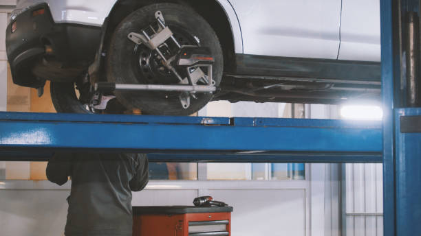 istock Checking the wheel in garage automobile service, close up 877018920