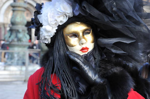 people wear black and red costume in carnival of venice, italy. february 12, 2013 - entertainment holidays and celebrations venice italy performer imagens e fotografias de stock