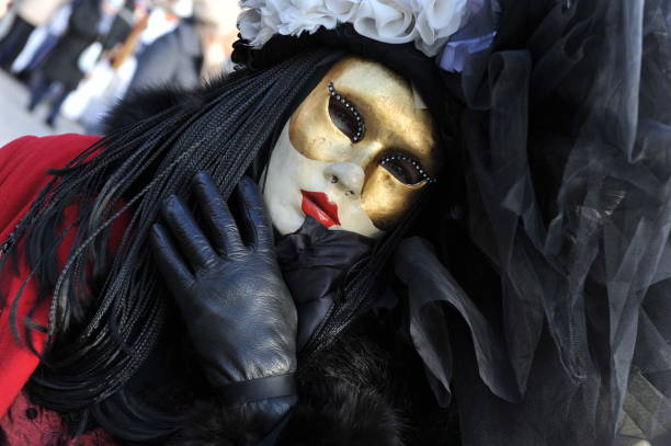 people wear black and red costume in carnival of venice, italy. february 12, 2013 - entertainment holidays and celebrations venice italy performer imagens e fotografias de stock