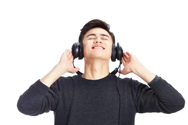 young asian man enjoying music with headphone, isolated on white background.