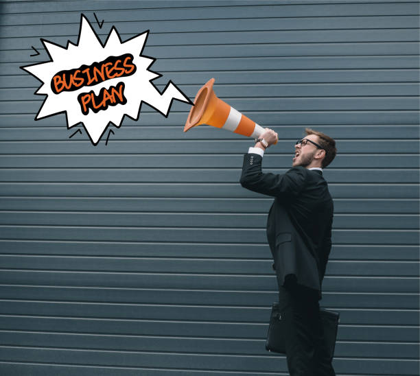 istock Businessman with traffic cone 877019638