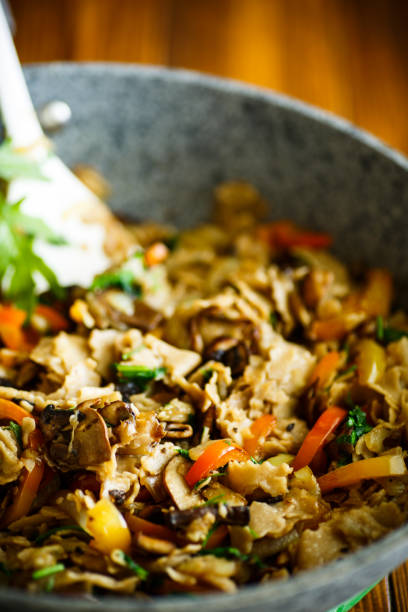 istock Buckwheat noodles with fried mushrooms and vegetables 877019818