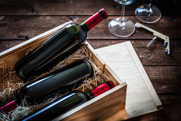 istock Wine bottles packed in a wooden box shot rustic wooden table 877022704