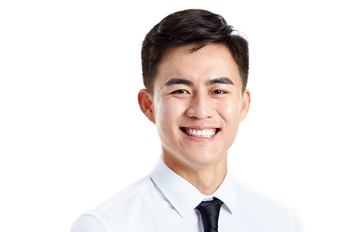 head shot of a young asian businessman, happy and smiling, studio shot, isolated on white background.