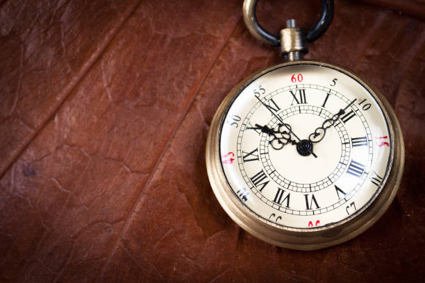 istock A pocket watch on dried leaf 877022950