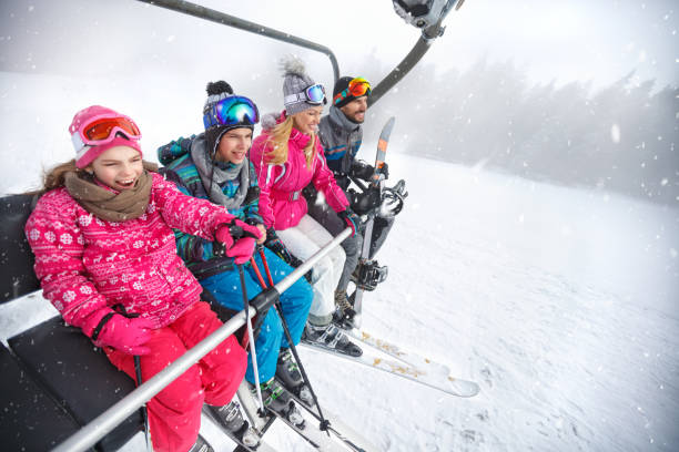 istock Family in ski lift going to ski terrain 877023326
