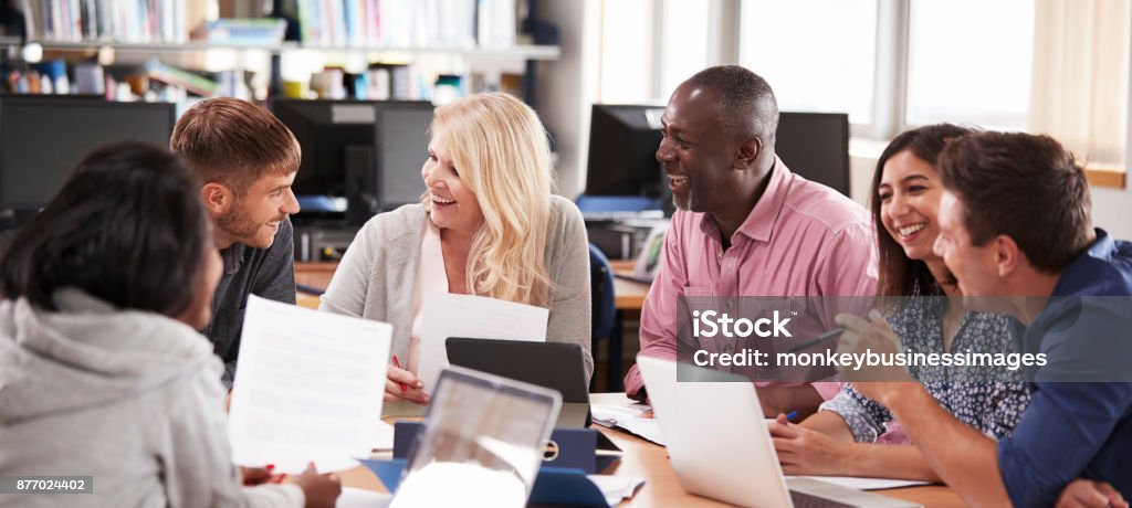 Group Of Mature College Students Collaborating On Project Learning Stock Photo