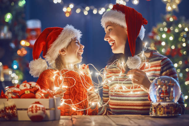 istock Mom and daughter near Christmas tree 877026268