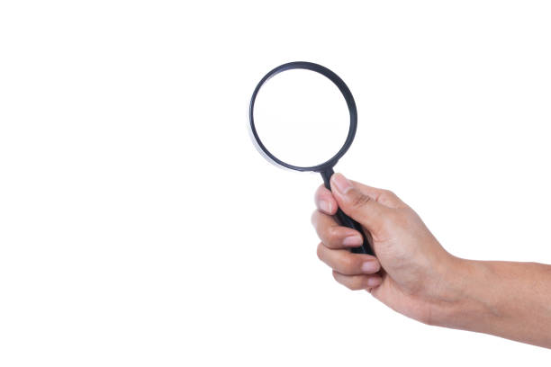istock Hand holding magnifying glass isolated on white background 877027014