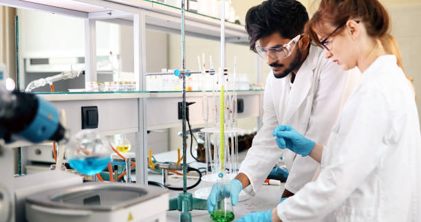 istock Young students of chemistry working in laboratory 877027308