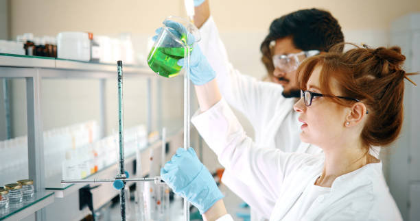 istock Group of chemistry students working in laboratory 877027358
