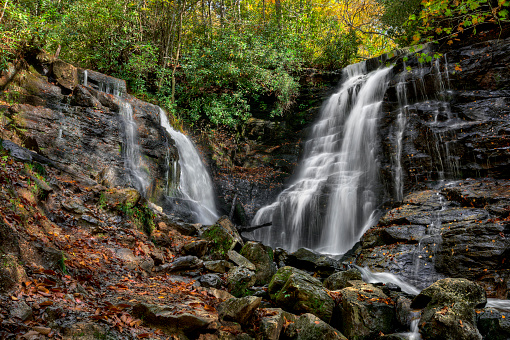 Soco Falls is a scenic 50 foot double waterfall not far from the Blue Ridge Parkway in North Carolina on US 19. Seen here in autumn.