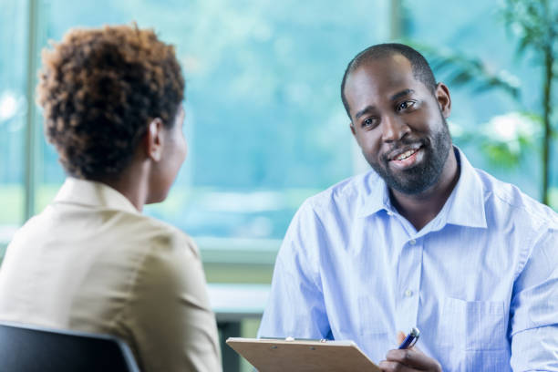 istock Male counselor discusses intake paperwork with new patient 877029562
