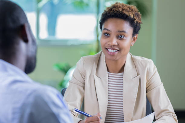 istock Young female counselor questions a new patient 877029576