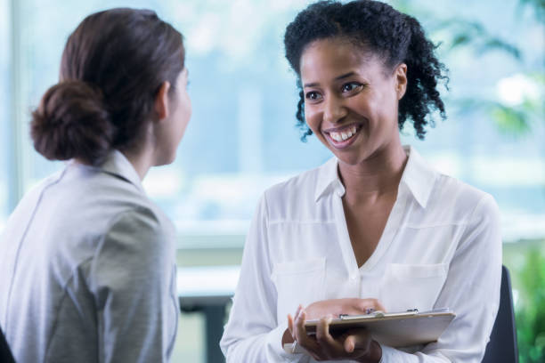 istock Female counselor bonds with new patient 877029580