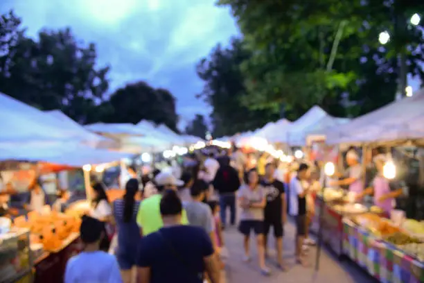 Photo of Blurred background of walking street market in bangkok thailand.Tourist walking at local street market for shopping in weekend