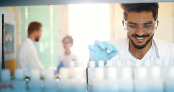istock Male student of chemistry working in laboratory 877030234