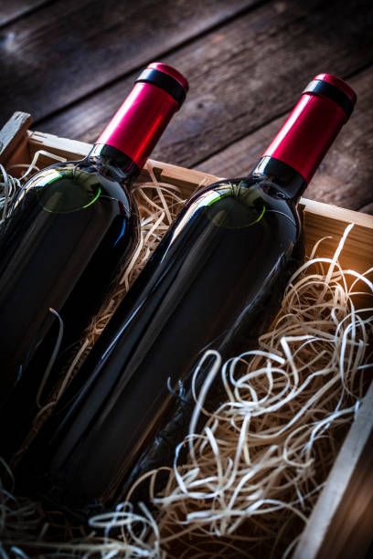 wine bottles packed in a wooden box shot rustic wooden table - wine wine bottle box crate imagens e fotografias de stock