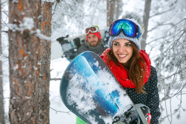 istock friends snowboarder having fun in the winter forest 877030682