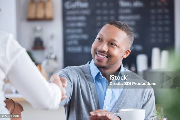 Businessman Meets Interviewee In Coffee Shop Stock Photo - Download Image Now - Interview - Event, Sneering, Job Interview
