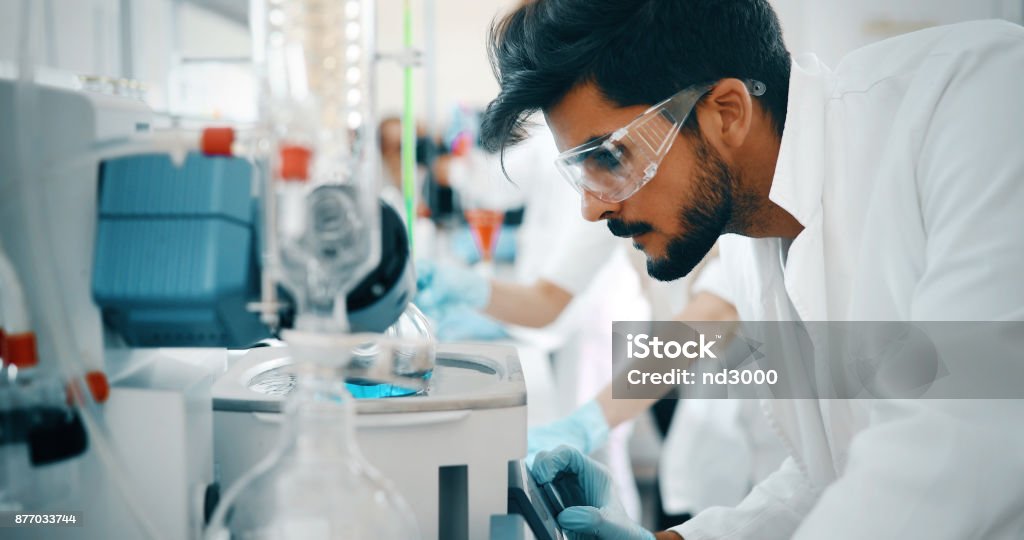 Young students of chemistry working in laboratory Young students of chemistry working together in laboratory Laboratory Stock Photo