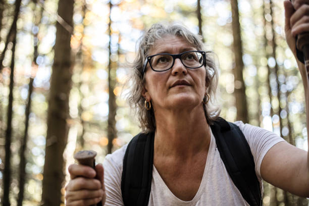 istock Mature Woman Hiking in Forest 877033838