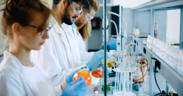 istock Young students of chemistry working in laboratory 877034160