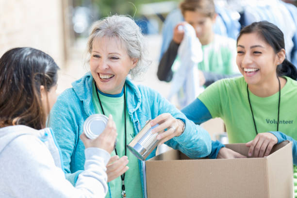 istock Diverse multi-generational friends volunteer together 877034602