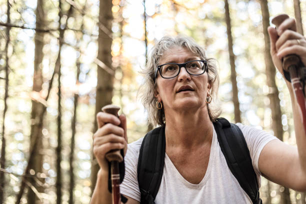 istock Mature Woman Hiking in Forest 877034784