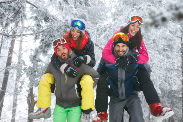 istock Group of friends having fun on the snow 877034976