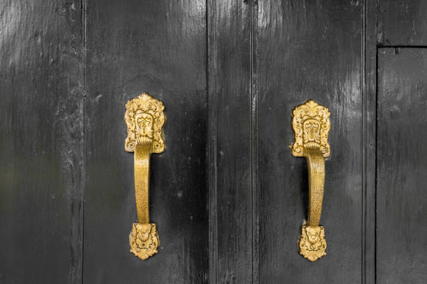 istock gold colored handle on black doors 877037746