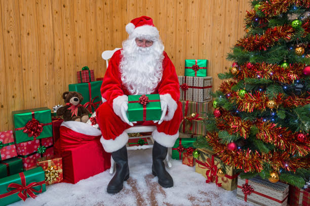 istock Santa Claus in a grotto giving you a gift. 877038010
