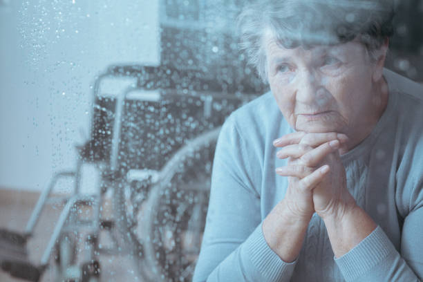 istock Disabled grandmother praying at home 877041734
