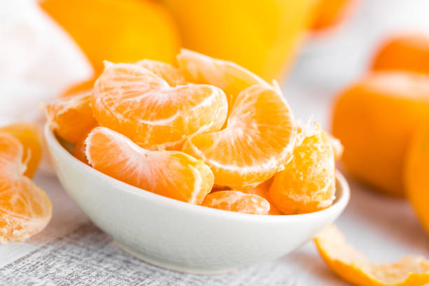 istock Fresh peeled mandarins, tangerines 877057626