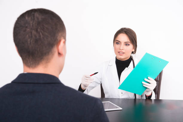 istock Doctor talking to a patient while holding a report 877060428