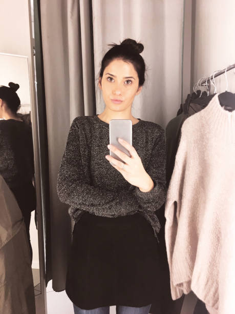 istock Young woman in a fitting room 877068358