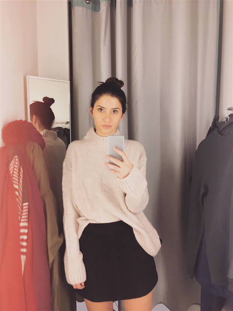 istock Photographing in a fitting room while trying clothes 877068370
