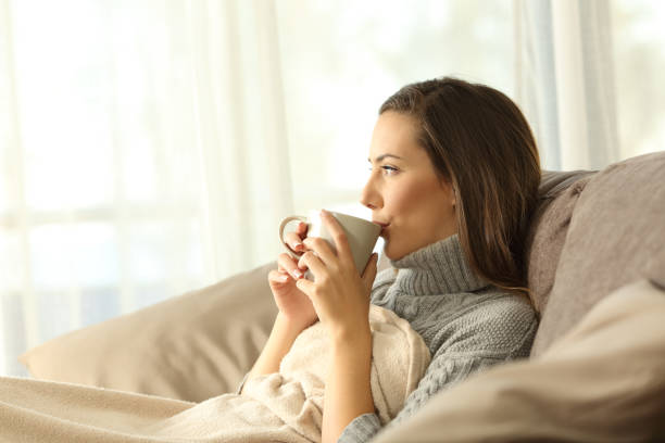 istock Woman relaxing at home drinking coffee 877068374