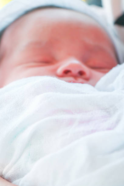 istock Newborn baby eyes closed sleeping 877068536